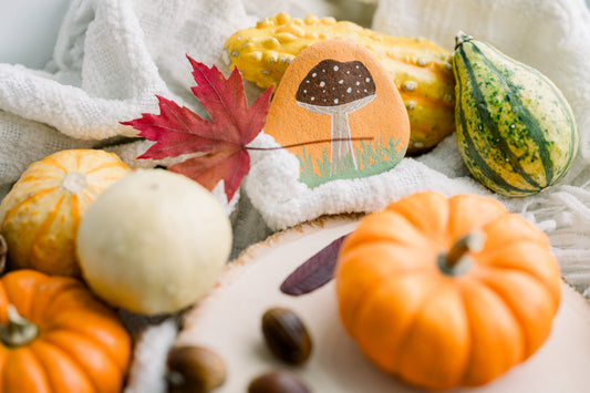 Colorful pumpkins and fall leaves with hand painted fall rock